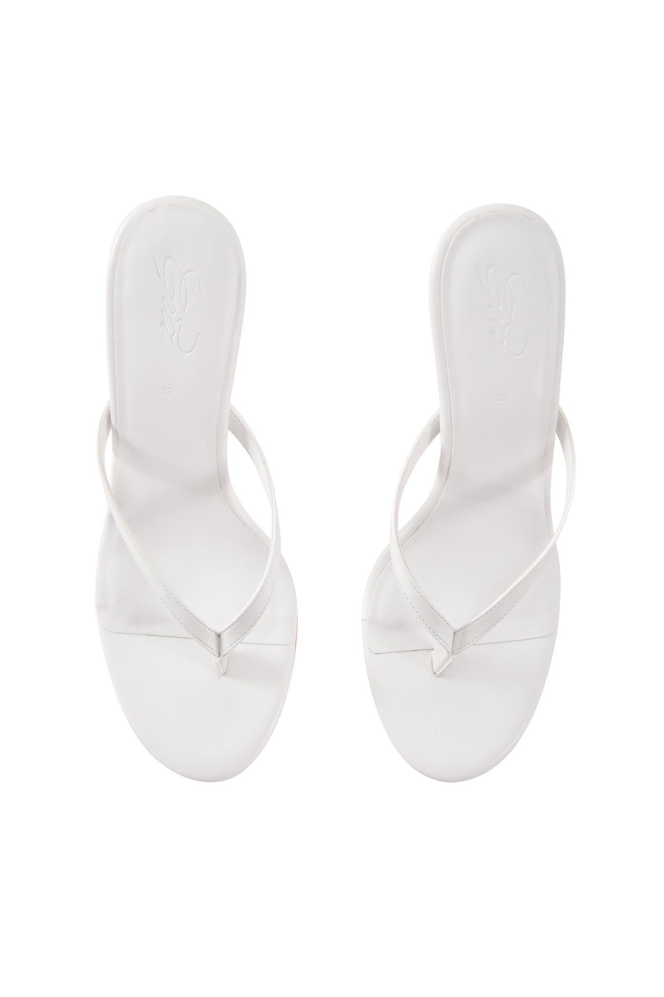The I.AM.GIA VIKTORIA WEDGE HEEL in white features a minimalist, faux leather slip-on mule design with thin straps, shown from above on a plain white background.