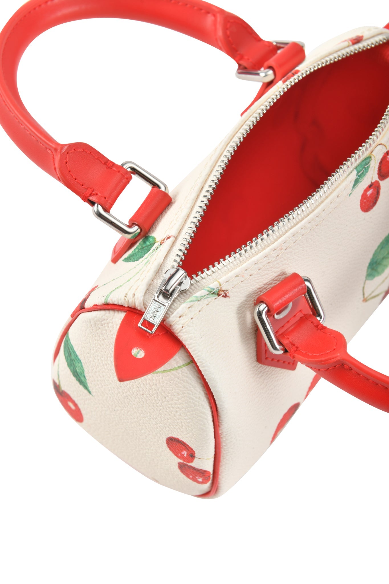 The I.AM.GIA NIKA MINI BAG in Cherry on Top features a white barrel design with red handles and zipper, playful print, bright red interior, and includes a removable shoulder strap for versatile carrying.