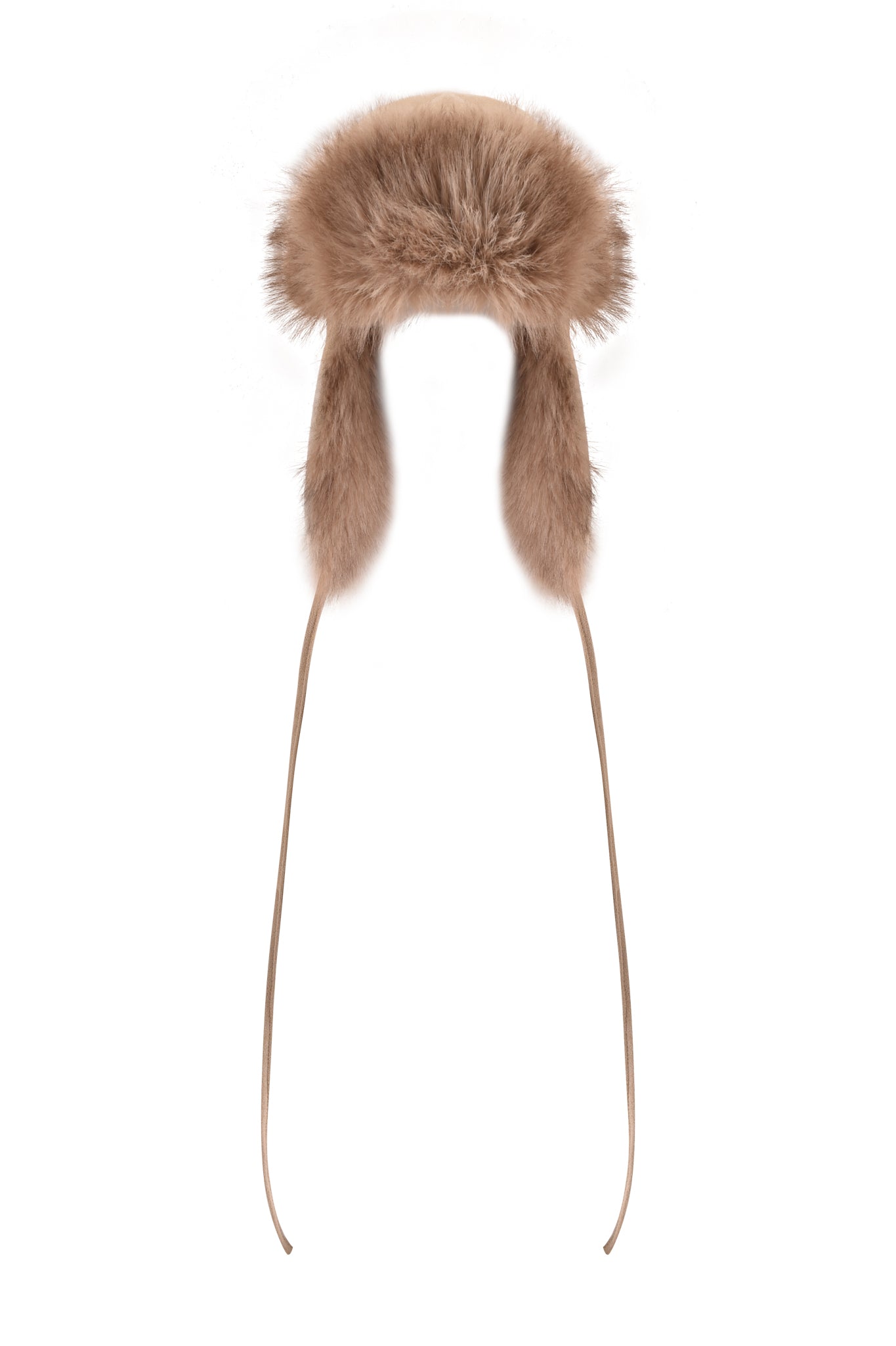 The I.AM.GIA GENA FAUX FUR TRAPPER HAT in tan suede is a fluffy, reversible accessory featuring soft faux fur, ear flaps, and long ties hanging down on both sides, shown against a white background.