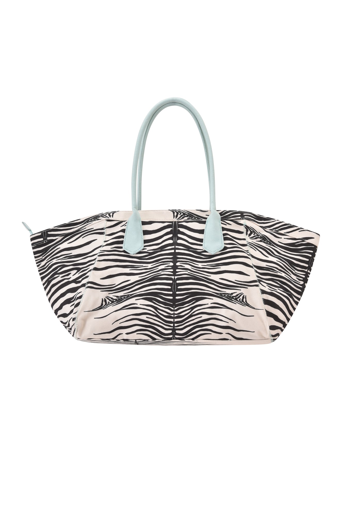 The BLARE TOTE BAG - FINE LINE ZEBRA by I.AM.GIA is a large, oversized shopper crafted from heavyweight cotton canvas, showcasing a bold black and white zebra print with light blue handles and beige side panels, displayed against a white background.