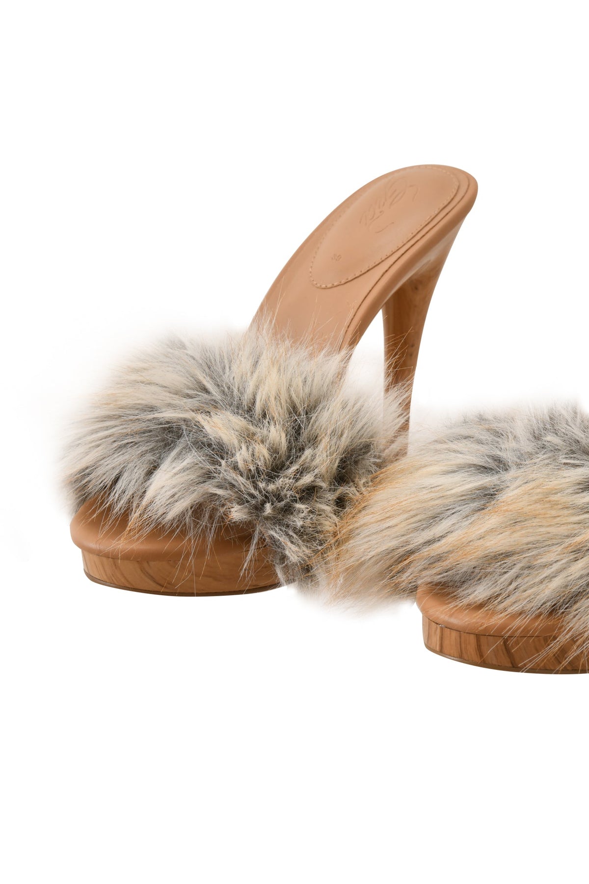 The NICKY HEEL - FAUX FUR TAN by I.AM.GIA showcases tan high-heeled slip-on mules with a thick, plush faux fur strap in gray, cream, and brown shades. Positioned on a white background, these shoes offer an elegant touch to any look.