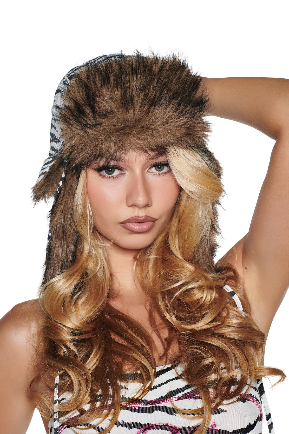 A person wearing an I.AM.GIA YVL FUR TRAPPER HAT - ZEBRA, featuring a brown faux fur trim and black-and-white patterned sides.