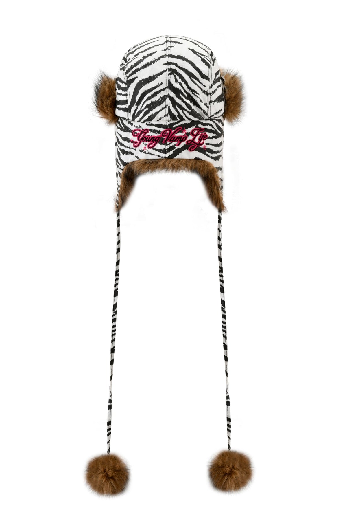 I.AM.GIA YVL FUR TRAPPER HAT - ZEBRA in zebra-print canvas with faux fur trim, pom-poms on long ties, and “Young Vamp Life” embroidered in pink on the front.