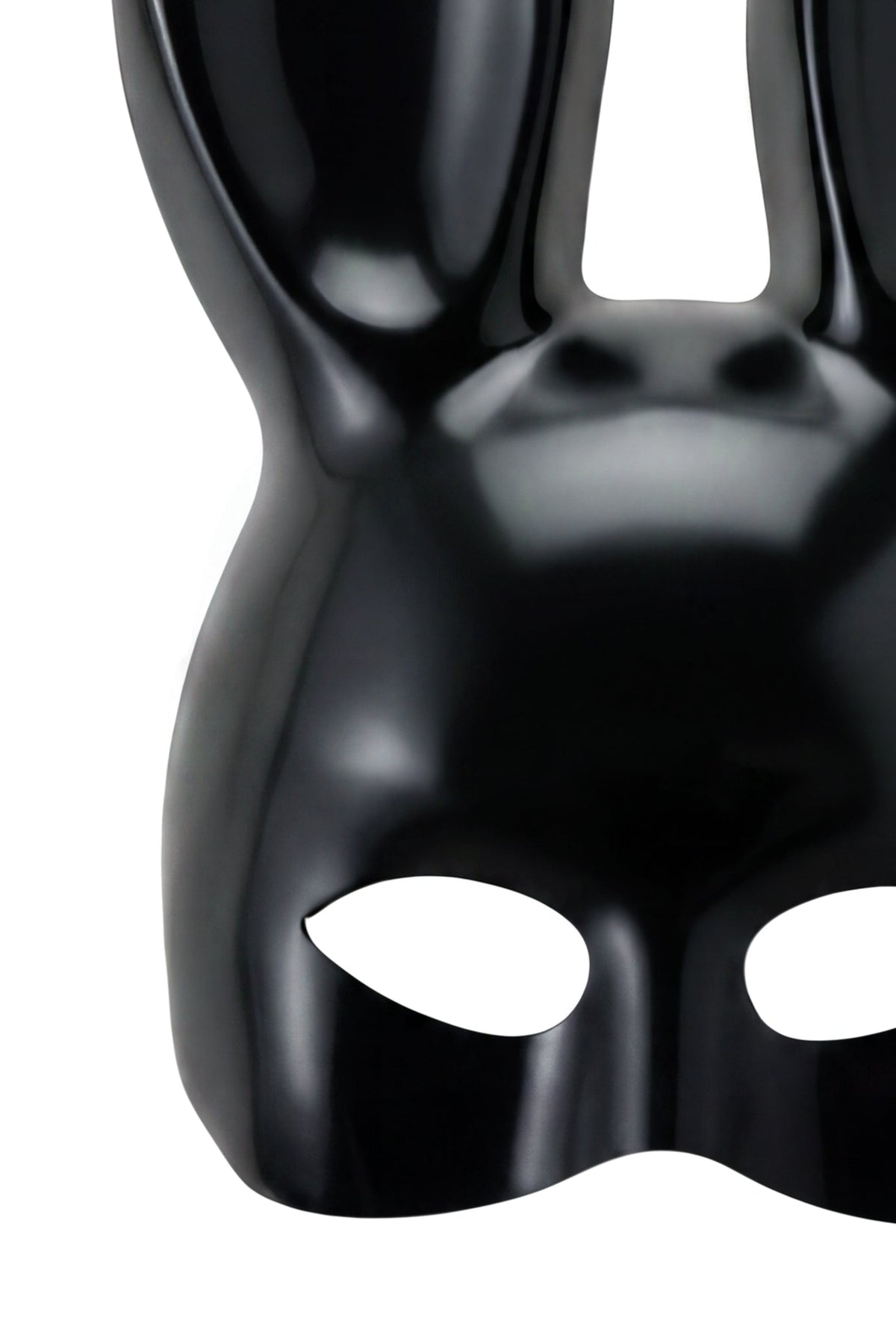 The DOE BUNNY MASK - BLACK by I.AM.GIA is a glossy black mask shaped like a rabbit’s face, with tall ears and eye cutouts—creating a bold Halloween costume accessory when showcased against a crisp white background.
