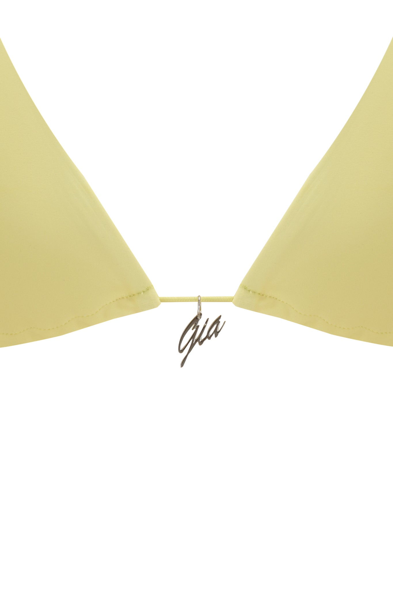 Close-up of the BAMBI BIKINI TOP - YELLOW by I.AM.GIA, featuring a pale yellow design and a small gold "Gia" pendant at the center string, from our Bambi Micro Bikini collection.