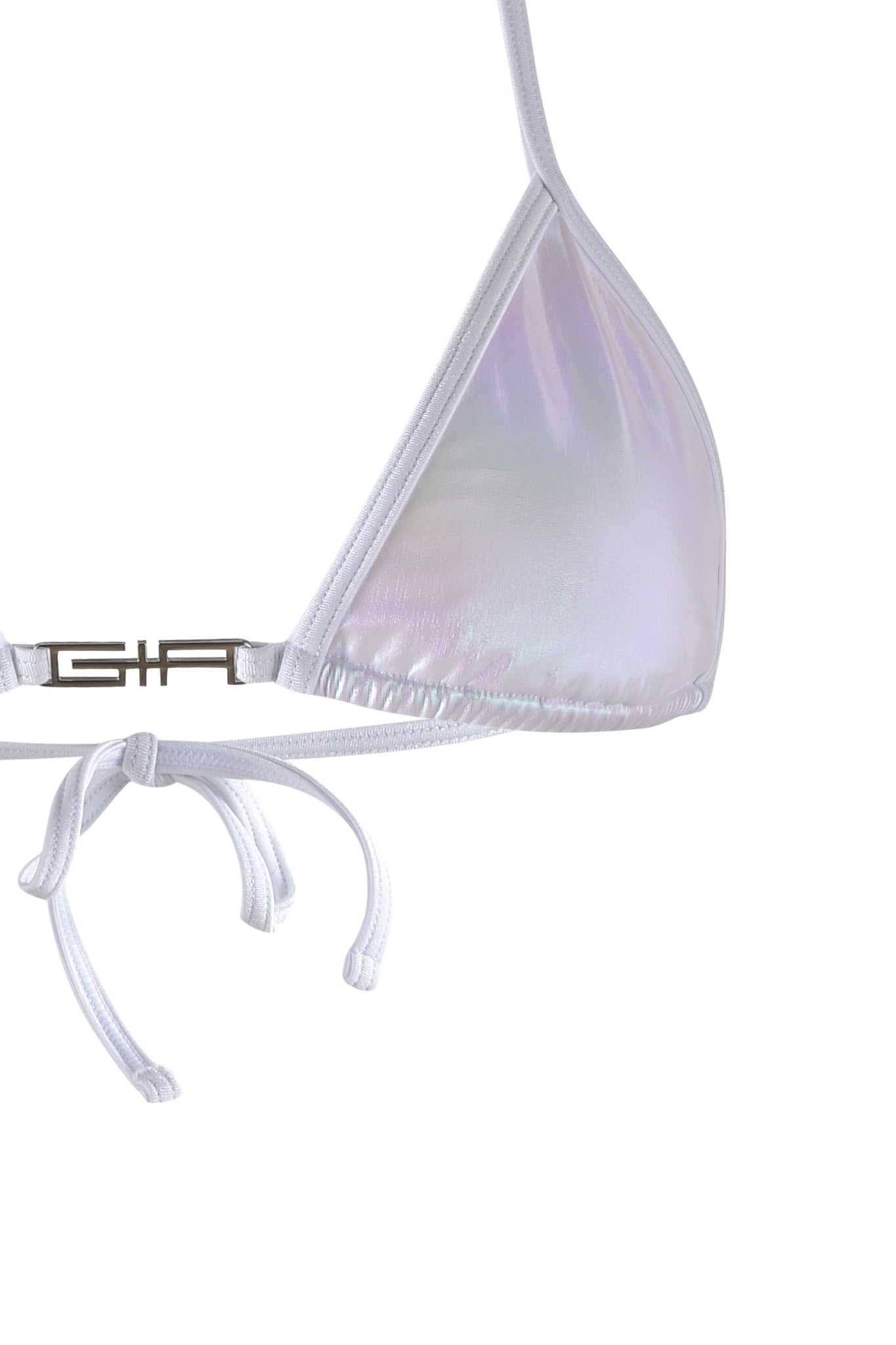 A close-up image of the ALOHI BIKINI TOP - WHITE : PEARL by I.AM.GIA features its thin straps and a small, metallic clasp on one side. The iridescent material reflects light, revealing subtle hues of purple and blue. The bottom straps are untied and dangle loosely.