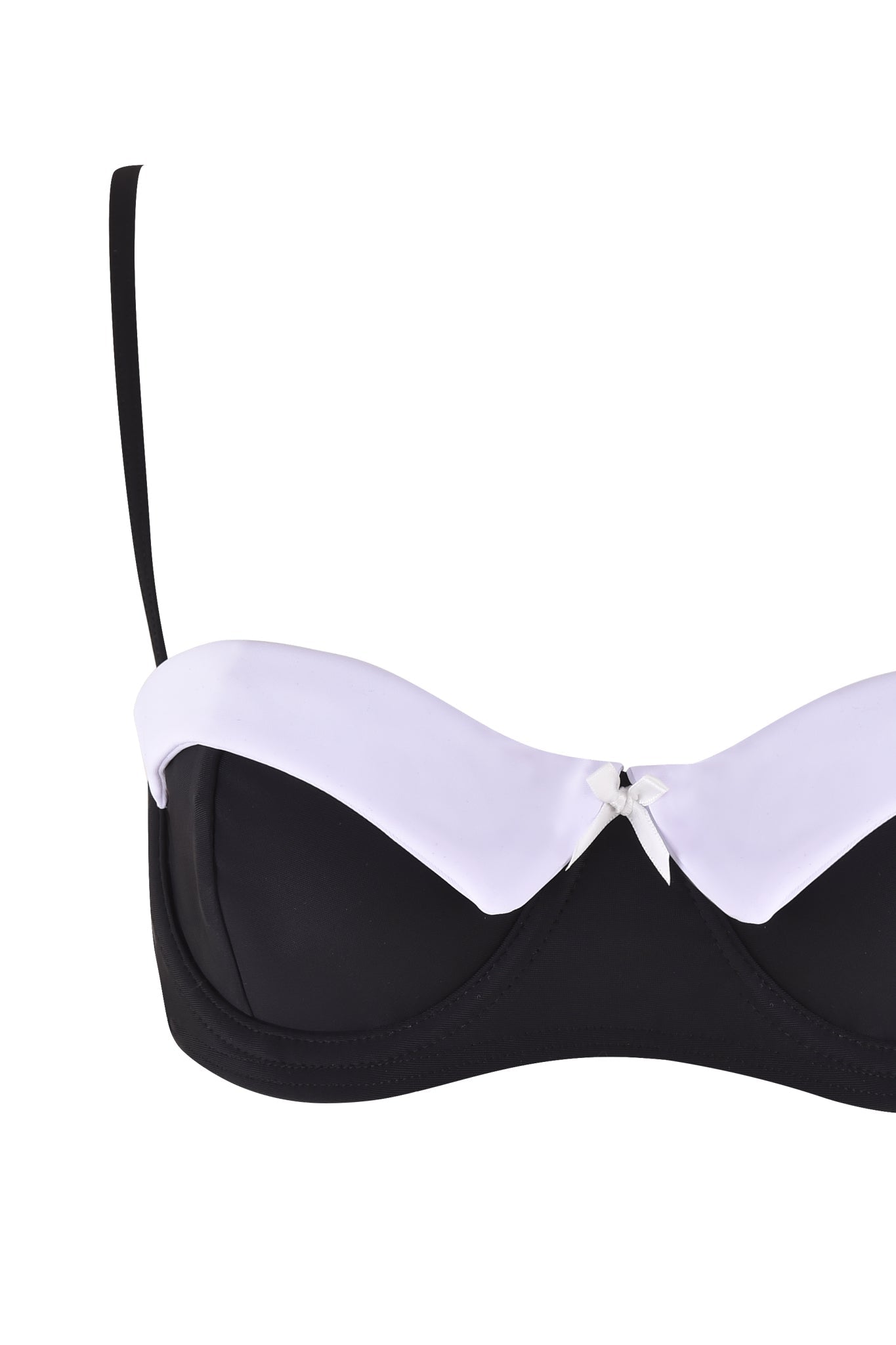 The DION TUXEDO BIKINI TOP - BLACK : WHITE by I.AM.GIA features a black, strapless design with a white band and an elegant white bow in the center. Its balconette shape provides support while the white band gracefully accents the top edge of the cups.