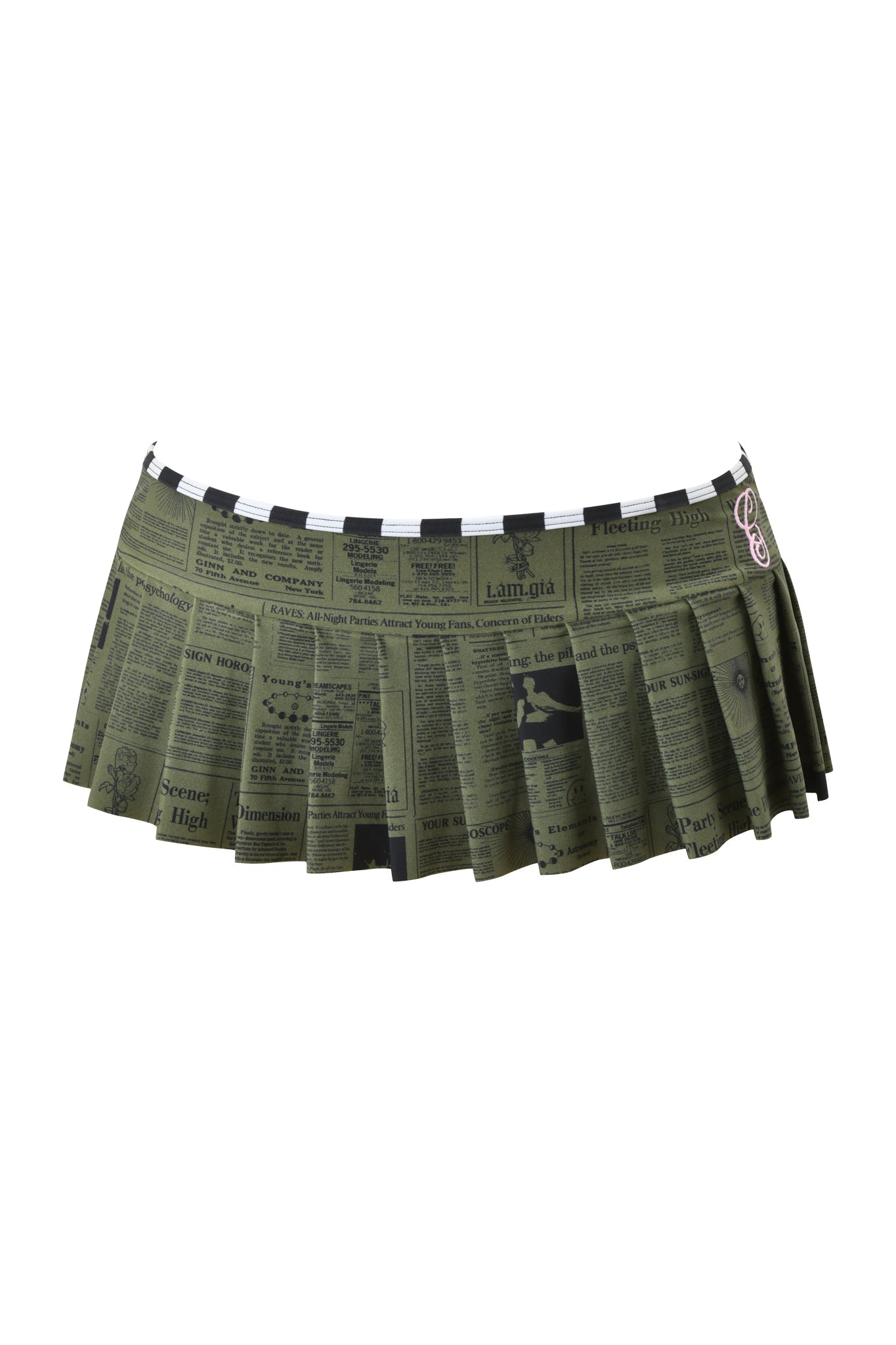 The AURETTE MICRO BIKINI SKIRT - LEFT ON READ by I.AM.GIA is a green pleated mini skirt with a black newspaper print, checkered waistband, and safety pin detail—ideal for fans of edgy micro mini styles.