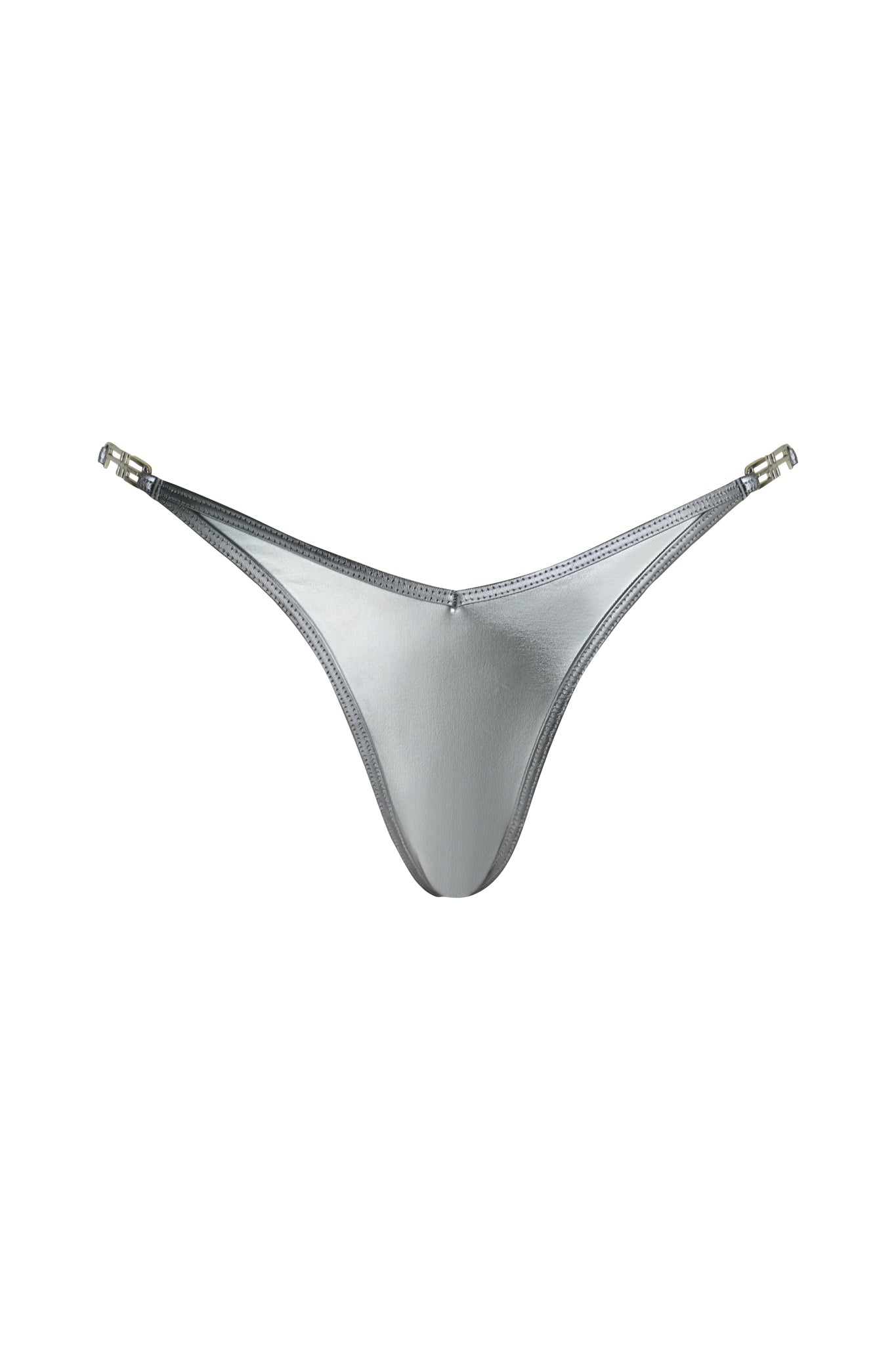 The LIOR BIKINI BOTTOM - SILVER by I.AM.GIA is a metallic silver thong with thin side straps and metal clasps on each hip, shown against a white background.