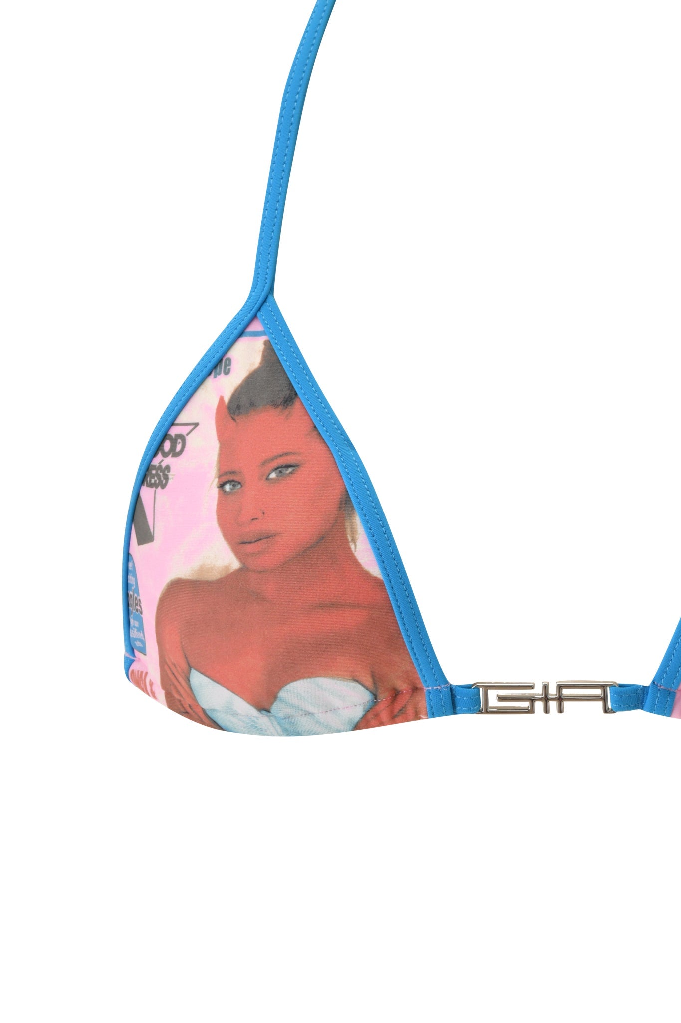 The T-REX AVA BIKINI TOP - PINK by I.AM.GIA features a triangle bikini top with blue trim and a bold graphic print of a red-skinned woman with small horns, stylishly dressed in a strapless white top. Set against a baby pink background with graphic accents, the look is completed with a metallic logo detail on the strap.