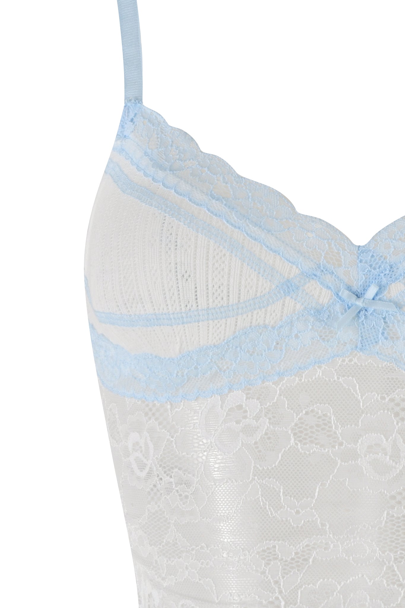 Close-up of the SERINA TANK - WHITE by I.AM.GIA, showcasing white lace with light blue lace trim and matching, adjustable shoulder straps. The top is adorned with a small, decorative light blue bow in the center. The stretch lace features a delicate floral pattern, and the fabric appears sheer.