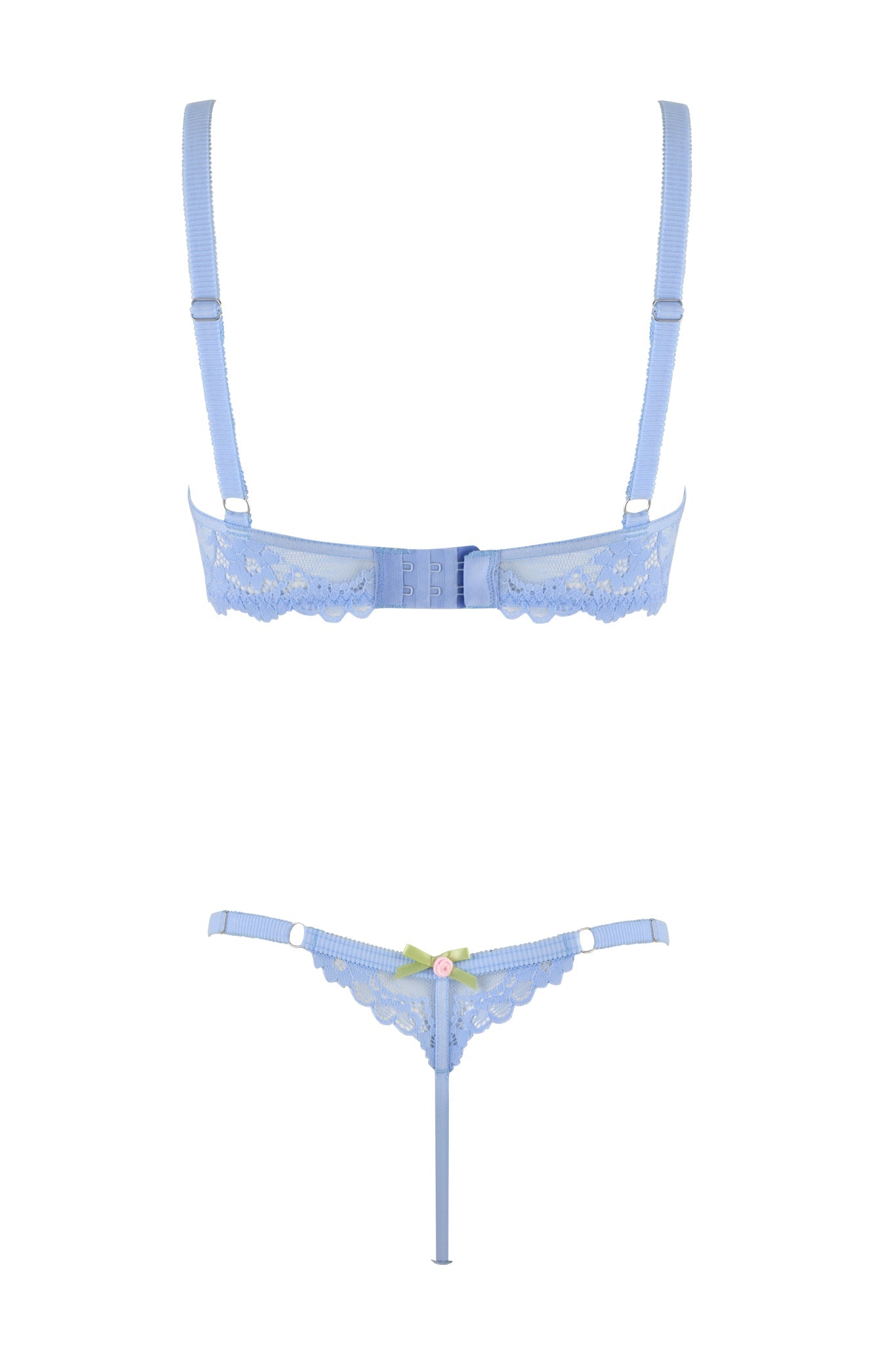 The CALLISTA SET - BLUE from I.AM.GIA features a light blue lingerie set that includes a lace bra with adjustable straps and a hook-and-eye closure at the back, paired with a matching lace thong adorned with lace trims, a green bow, and pink rose detail on the front. The set is displayed against a plain white background.
