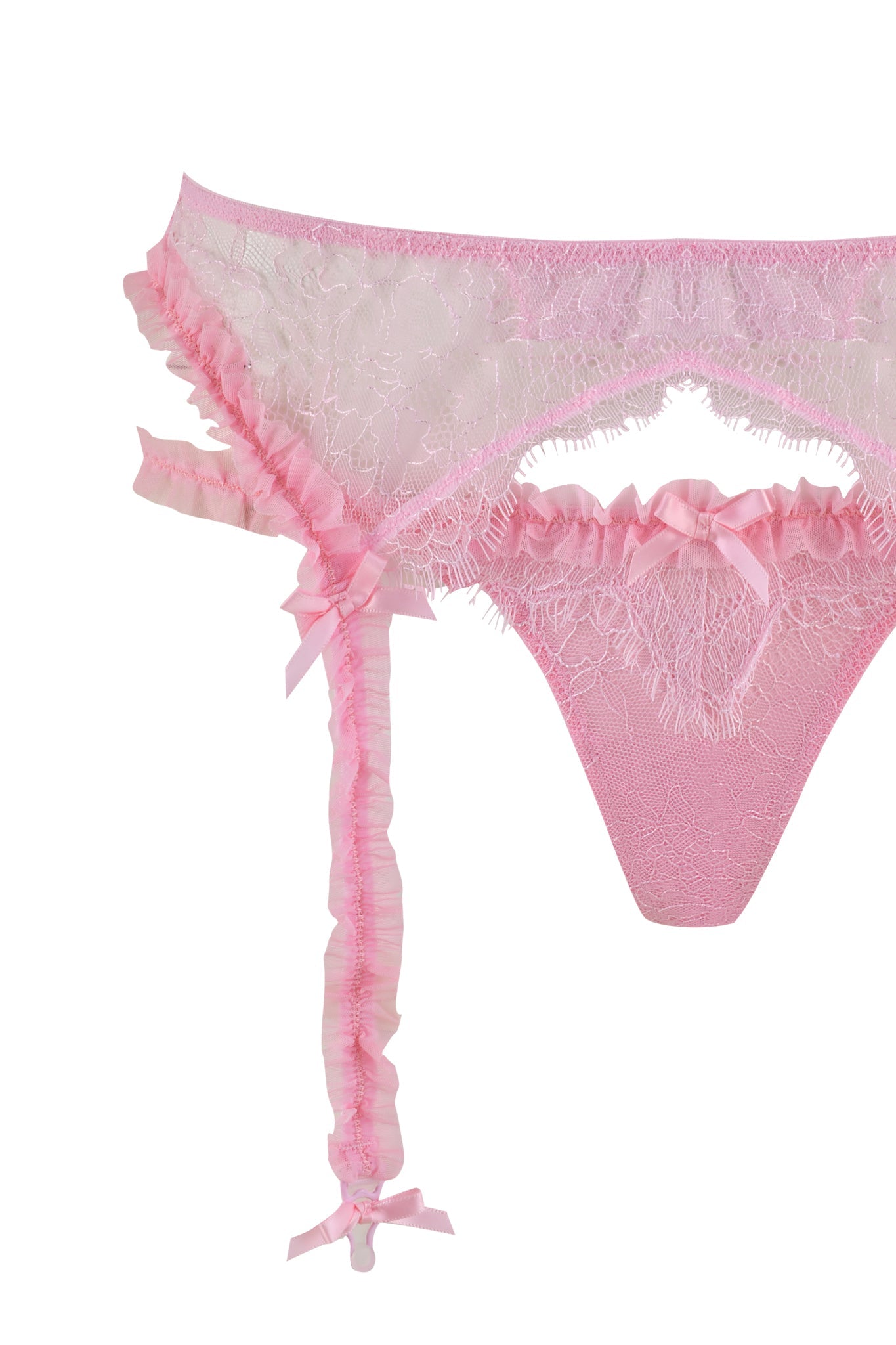 The MADISON 3 PIECE SET - PINK by I.AM.GIA features a pink lace lingerie set with delicate ruffle details and small bow accents. This intricate floral-patterned design includes a lace thong, an adjustable bra, and highlights a single garter strap on the left side. The image is expertly isolated on a white background.