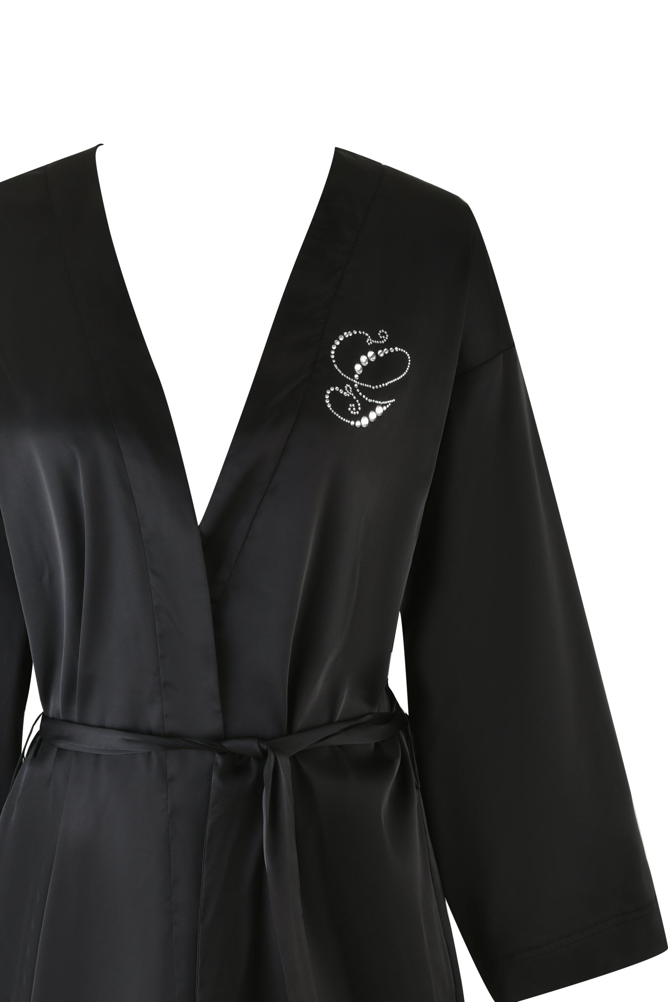 The LARSA 2.0 SLEEP ROBE - BLACK by I.AM.GIA, made from luxurious satin, showcases a black silk design with a deep V-neckline and a tie belt. It features an embroidered pattern of two intertwined hearts on the chest, along with an intricate butterfly diamante detail, all set against a plain white background.