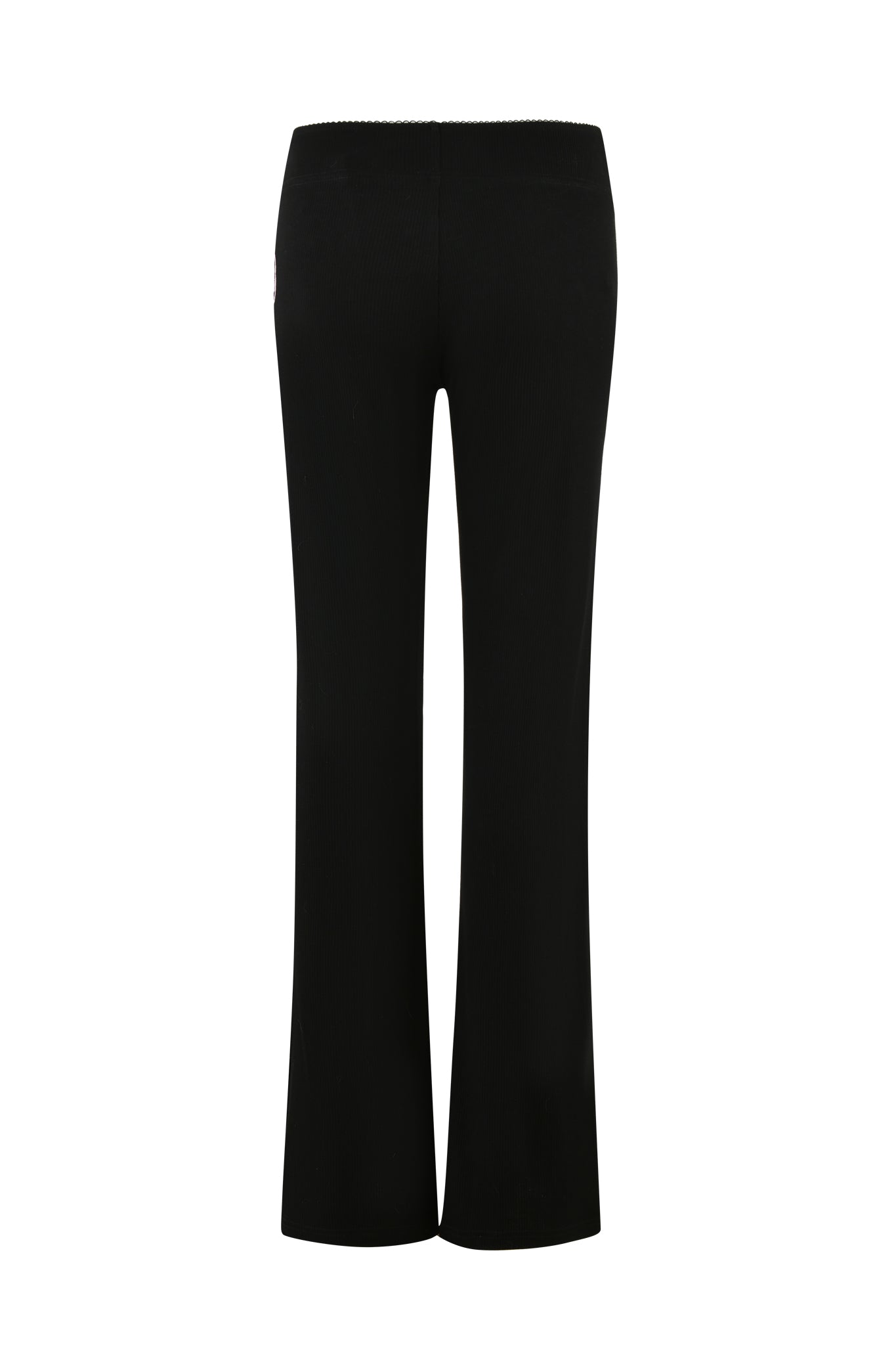 The ASTRID PANT - BLACK from I.AM.GIA features a ribbed knit texture, displayed from the rear view. These pants boast a slightly flared leg design and a seamless waistband, offering a sleek and classic appearance. The white background accentuates the garment's details.