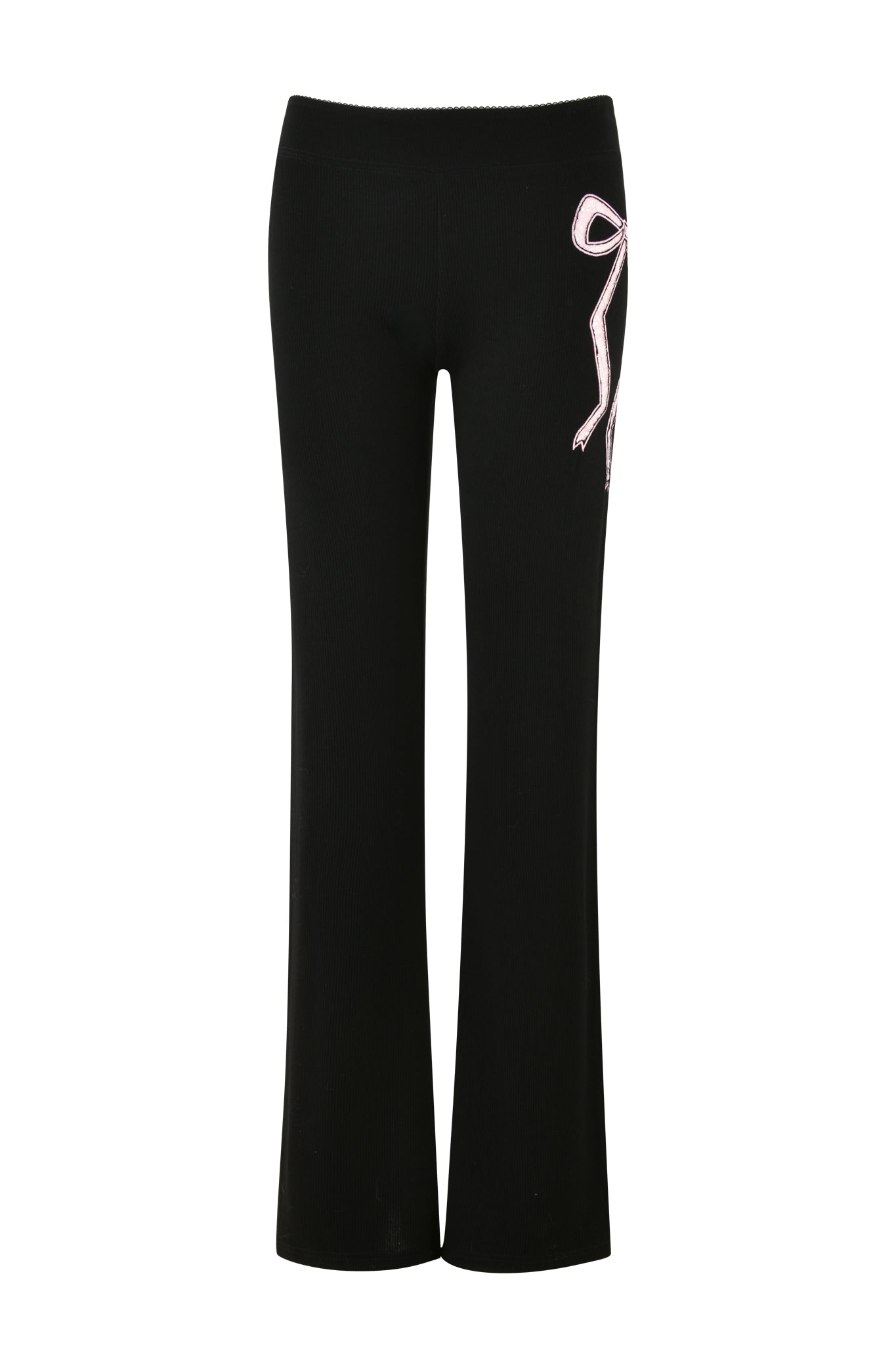 The ASTRID PANT - BLACK by I.AM.GIA showcases a straight-leg design with a decorative pink and white ribbon bow located on the right side near the waistband. Crafted from ribbed knit fabric, these pants provide a textured appearance, making them ideal for stylish sleepwear. They are pictured against a white background.