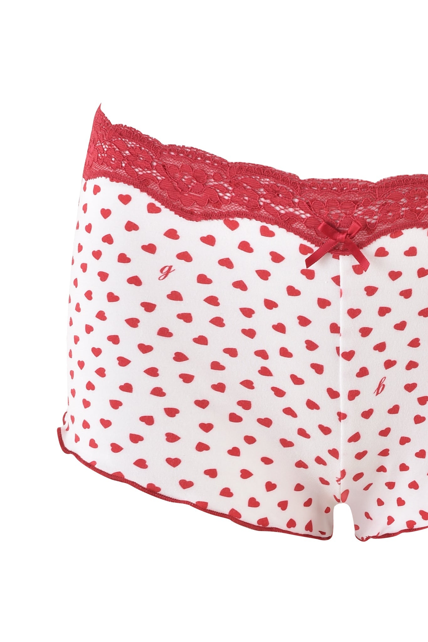The CASSIA SHORT - WHITE : DIGITAL : HEARTBEAT by I.AM.GIA features small red heart prints and a decorative red lace waistband with a bow at the front.