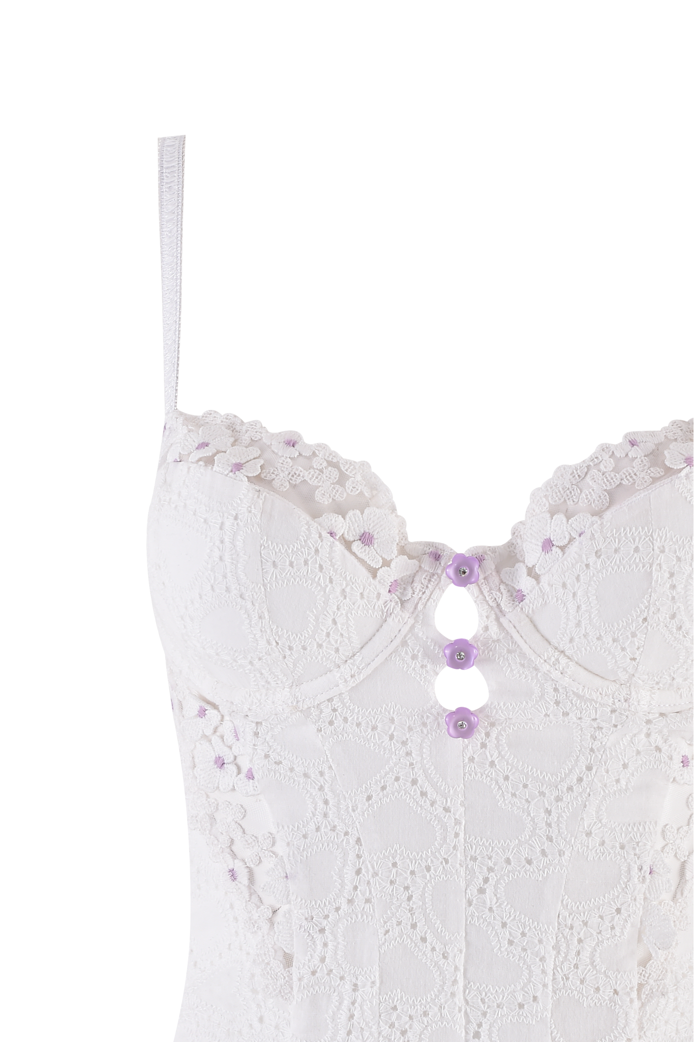 A close-up of the ELLA BUSTIER SET - WHITE by I.AM.GIA, showcasing cotton construction, sheer floral tulle, lavender buttons, and delicate lavender flower details along the top edge.