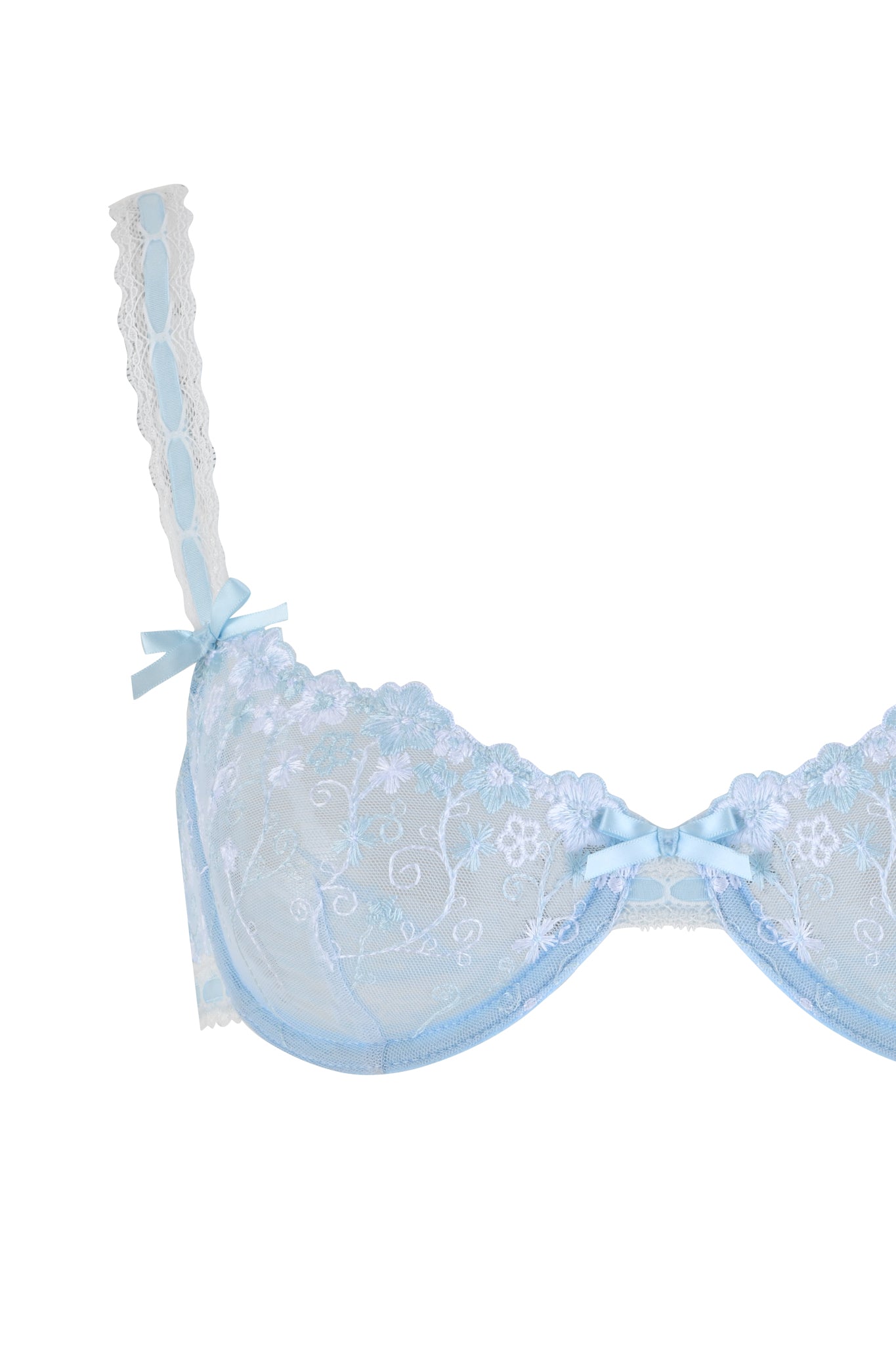 The ROMY 2 PIECE SET - BLUE by I.AM.GIA includes a light blue bra with floral lace embroidery, charming bows on the straps and center, lace detailing, and an underwire for support.