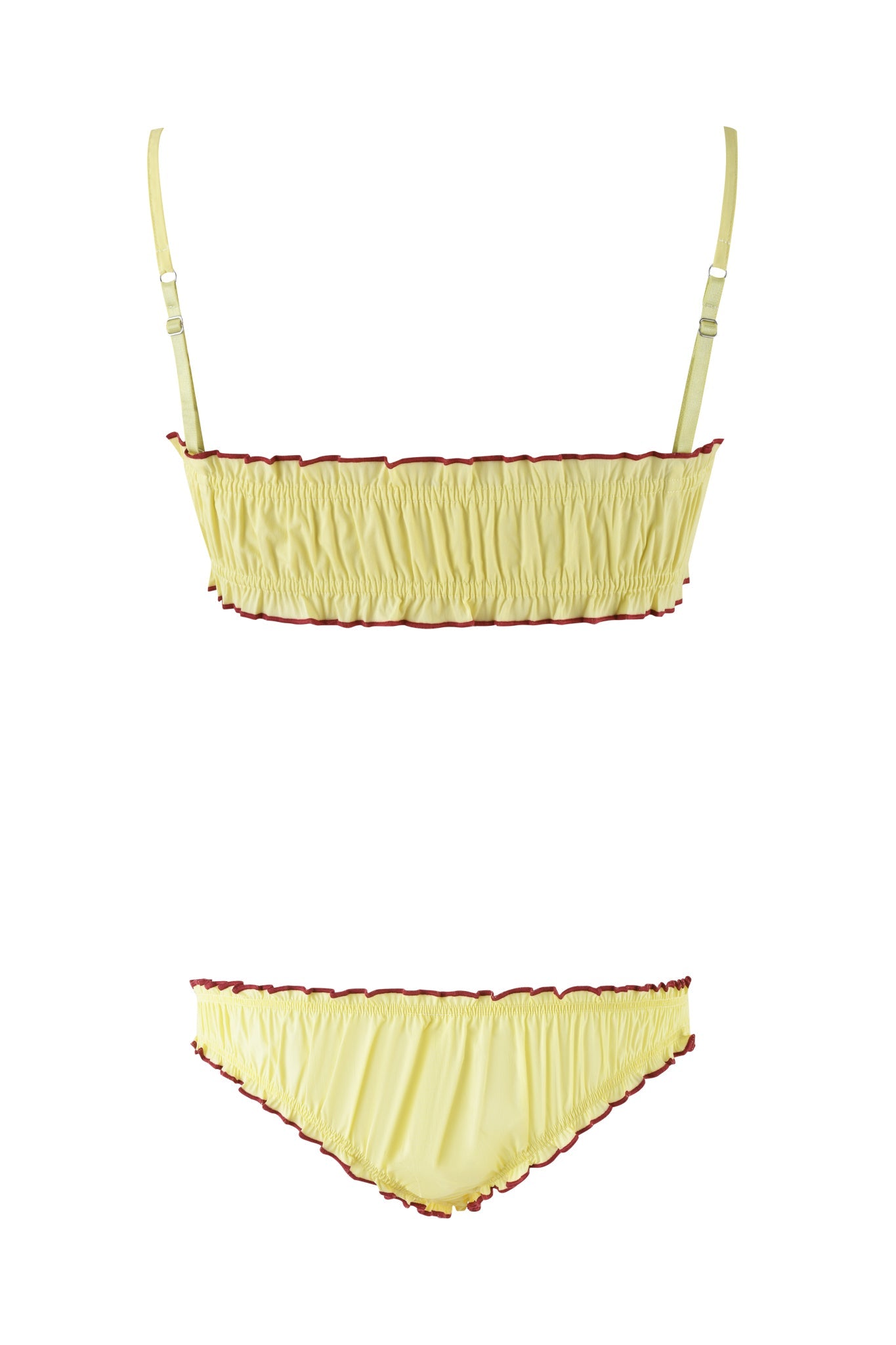 The CLOVER SET - YELLOW by I.AM.GIA includes a yellow two-piece lingerie set with a bandeau bralette and matching bottoms, both with ruffled edges and red trim. The top features adjustable straps, and the fabric has a smooth appearance, displayed on a white background.