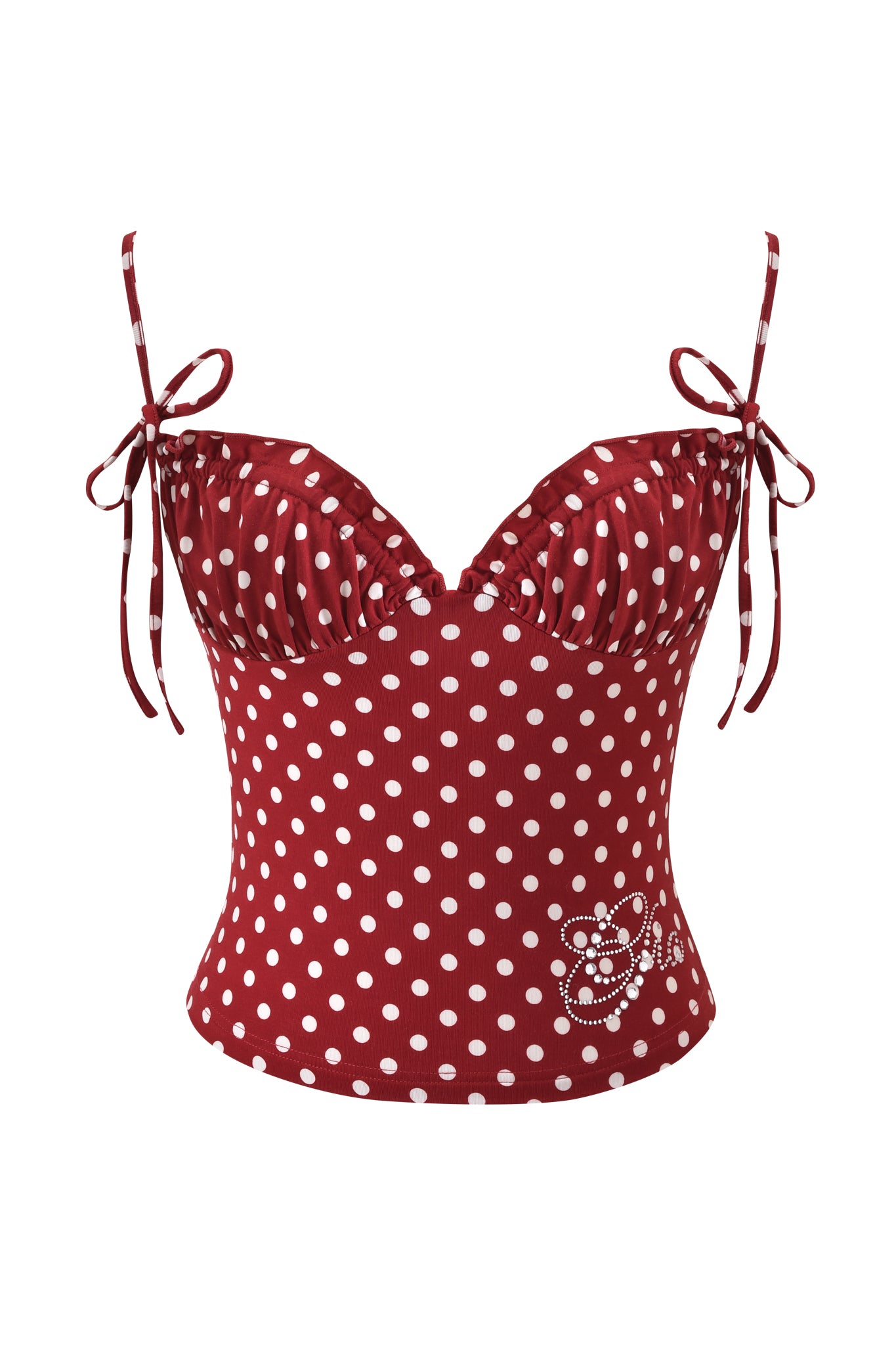 The MELANIE CAMI - RED POLKA DOT by I.AM.GIA features thin bow-tied straps, an adjustable ruched bust, and a sparkling bear face diamante logo near the hem.