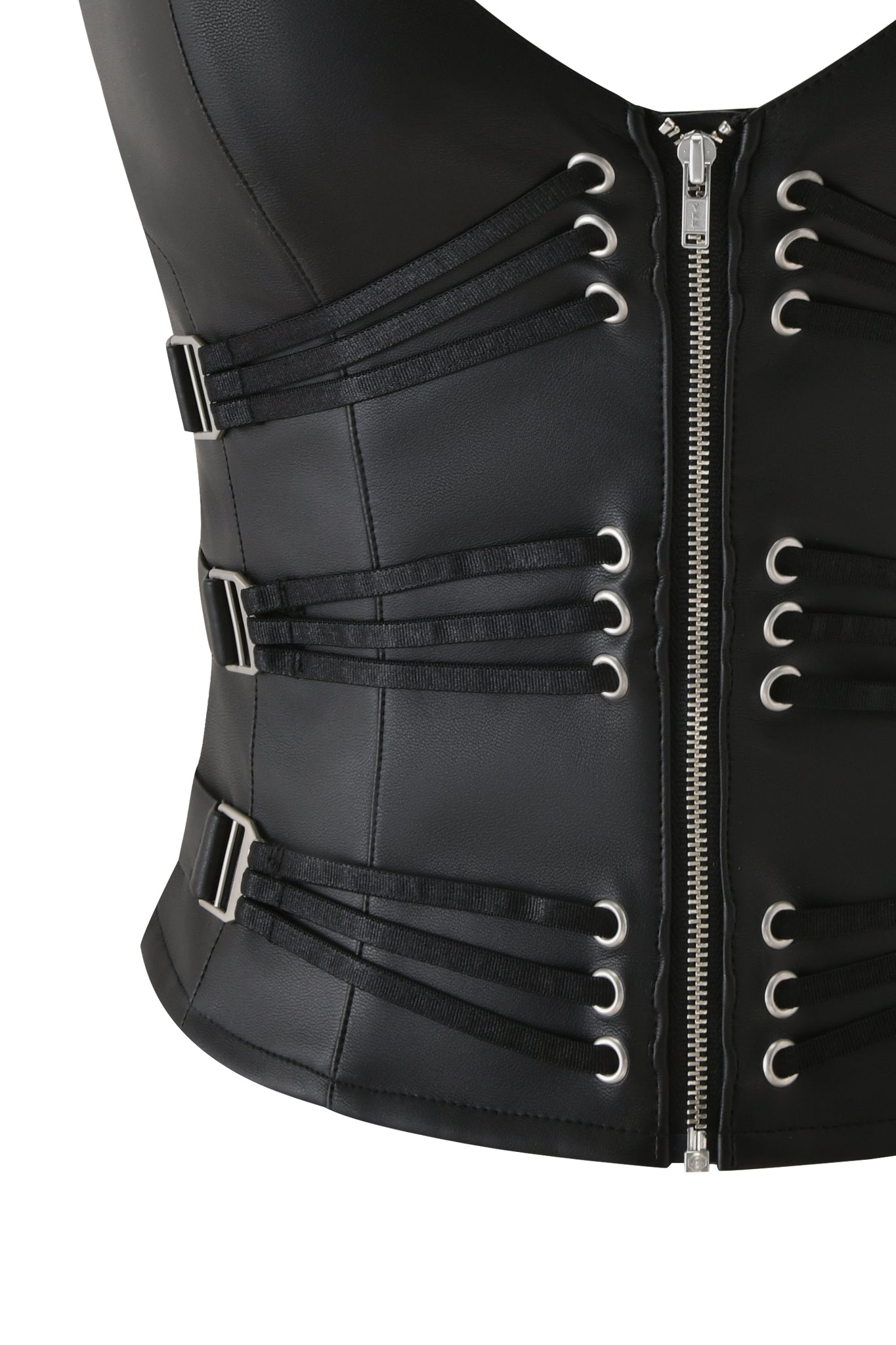 The SIBARI CORSET TOP by I.AM.GIA is a black faux leather racerback design featuring a front zipper, silver grommets, multiple adjustable buckle straps, and decorative black side bands.