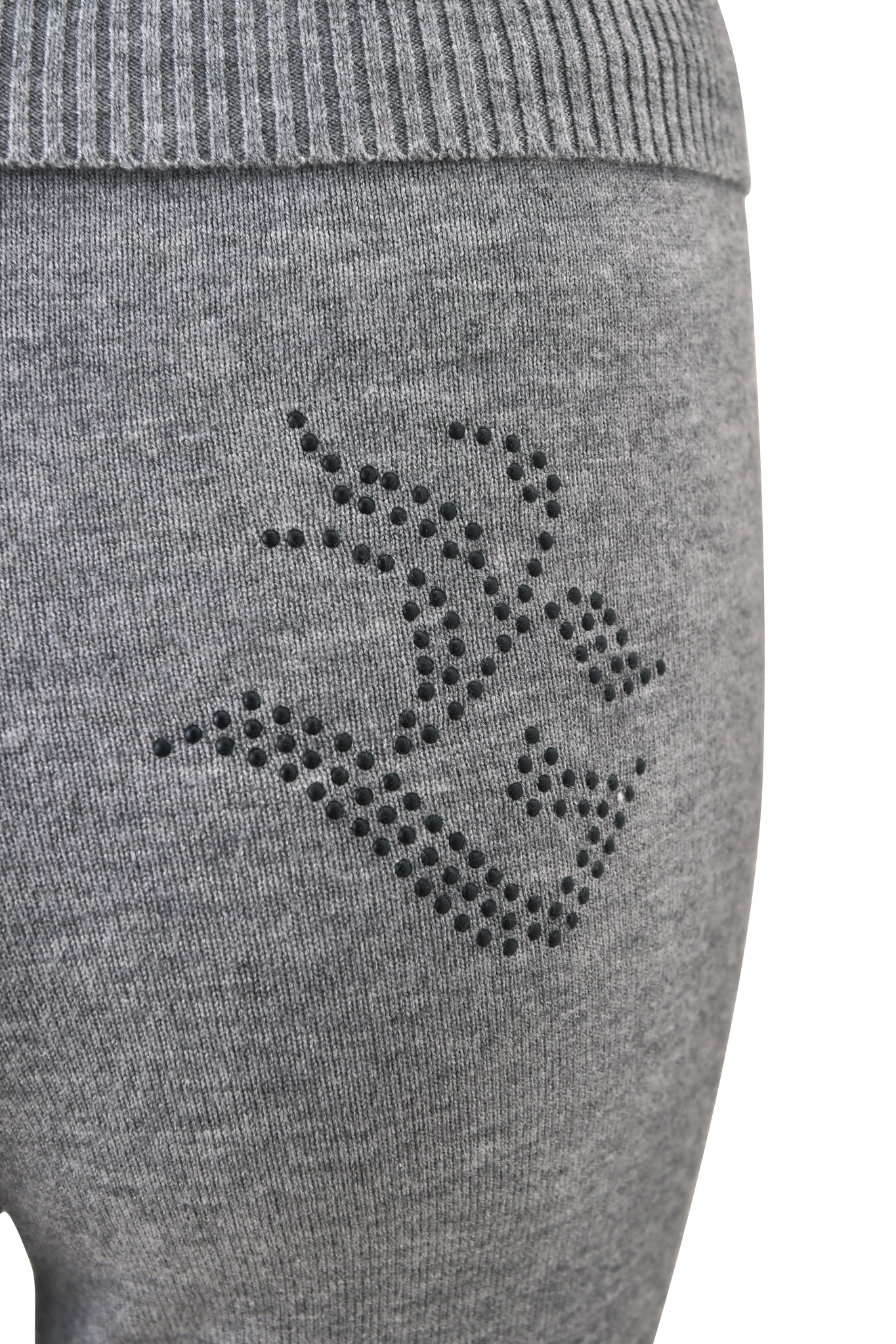 Close-up of the I.AM.GIA JESSA PANT - GREY: a charcoal knit lounge pant with mid-rise waist and black decorative small round studs on the hip.