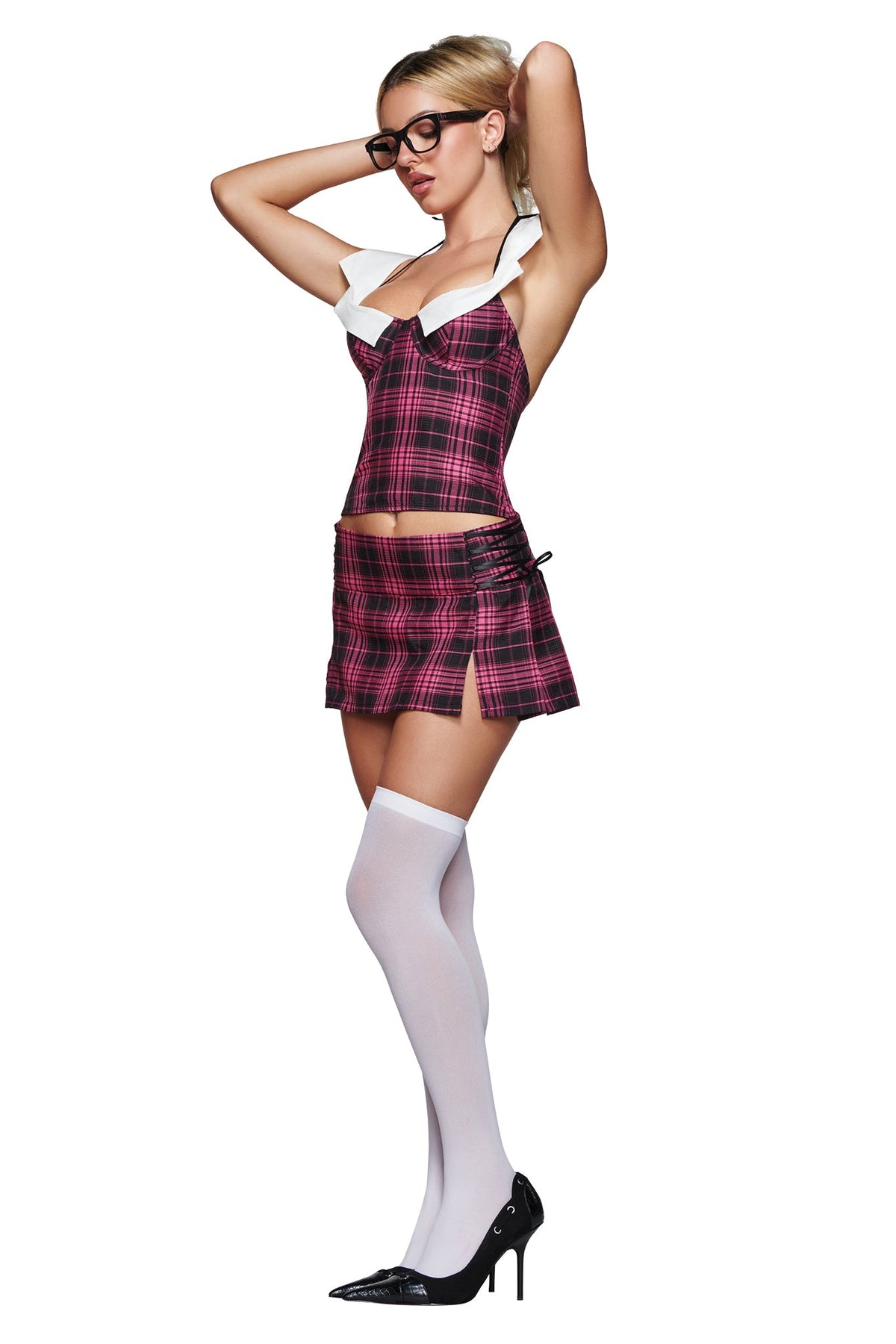 A person wearing the I.AM.GIA SOFI MINI SKIRT in pink plaid with a coordinated outfit, white thigh-high stockings, black heels, and glasses poses with hands behind their head against a white background.