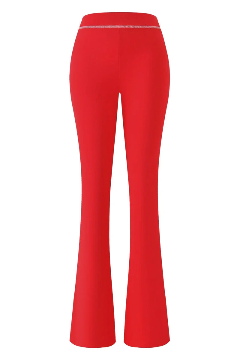 The I.AM.GIA X SEXYY RED BLARE TRACKPANT in red is shown from the back, featuring a fitted waist and hips with slightly flared legs, crafted in soft bamboo fabric.