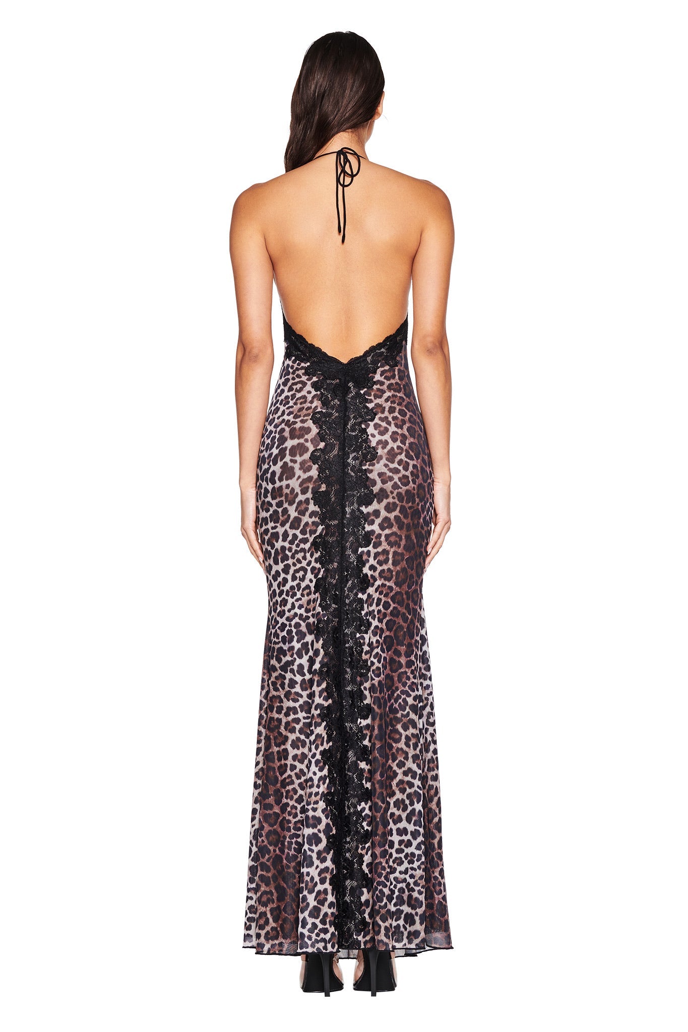 A woman is seen from behind wearing the I.AM.GIA HAVEN MAXI DRESS - CLASSIC LEOPARD, a halter neck maxi with a low-cut back, black lace center panel, and mermaid silhouette.