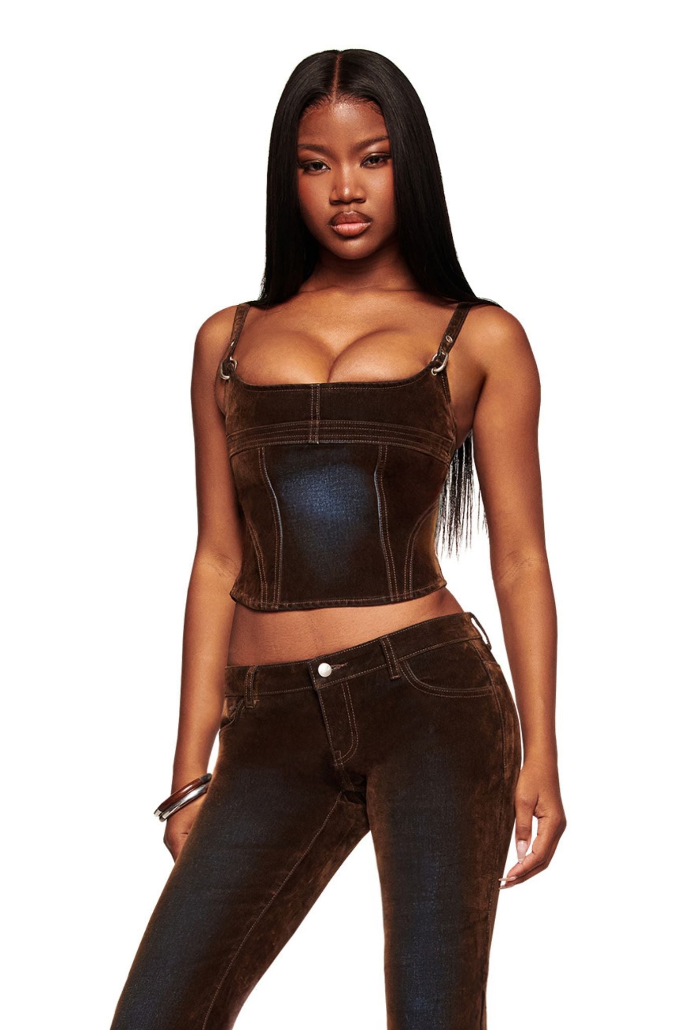 A woman with long straight hair confidently poses in the VIVAINE DENIM CORSET TOP - NEUTRAL by I.AM.GIA, paired with matching high-waisted pants, against a plain white background.