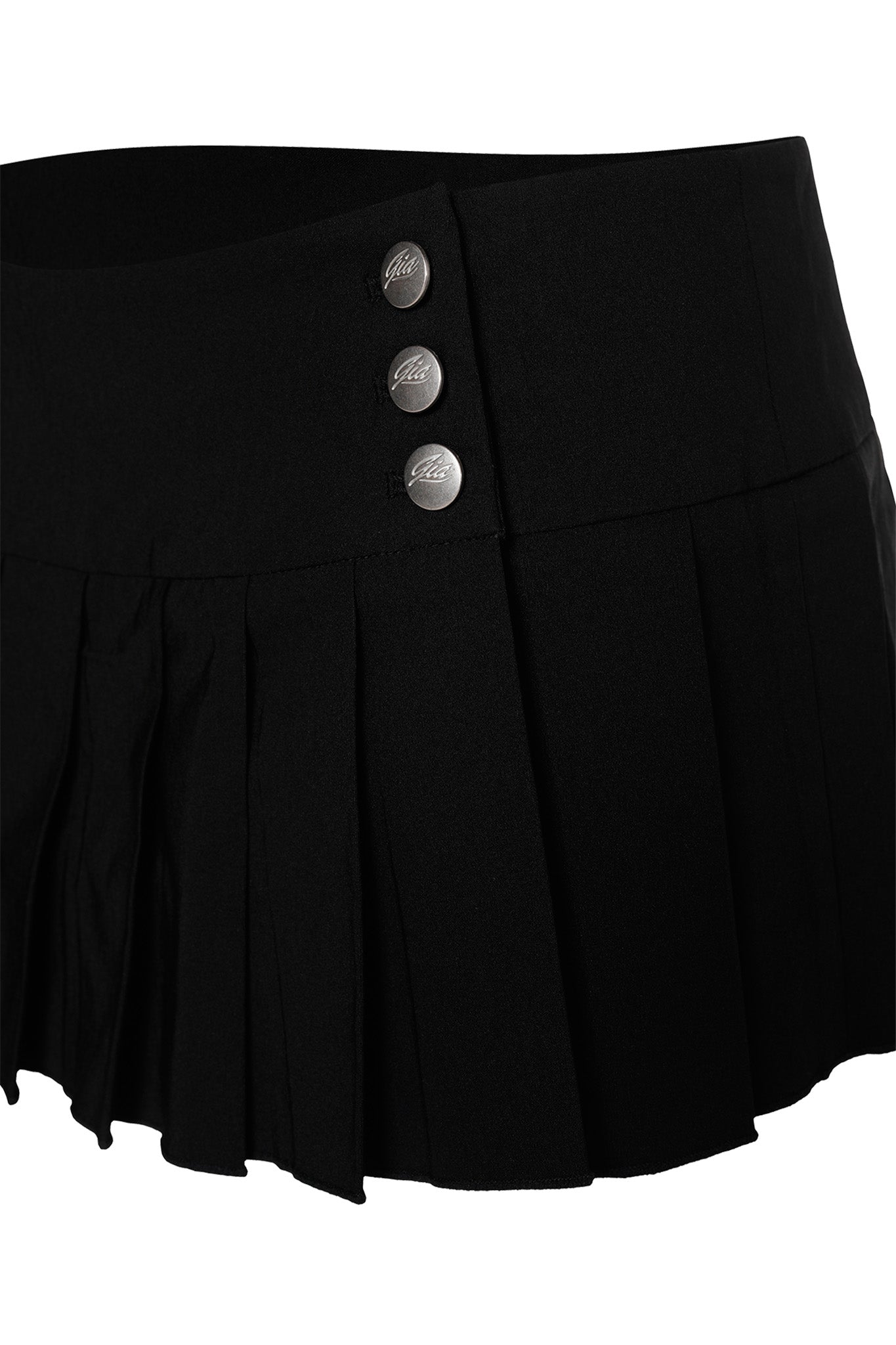 The REMINI SKORT - BLACK from I.AM.GIA features a fitted waistband with three silver buttons along the left side. Its uniform and elegant design, coupled with smooth fabric, gives the skort a sleek and polished look.