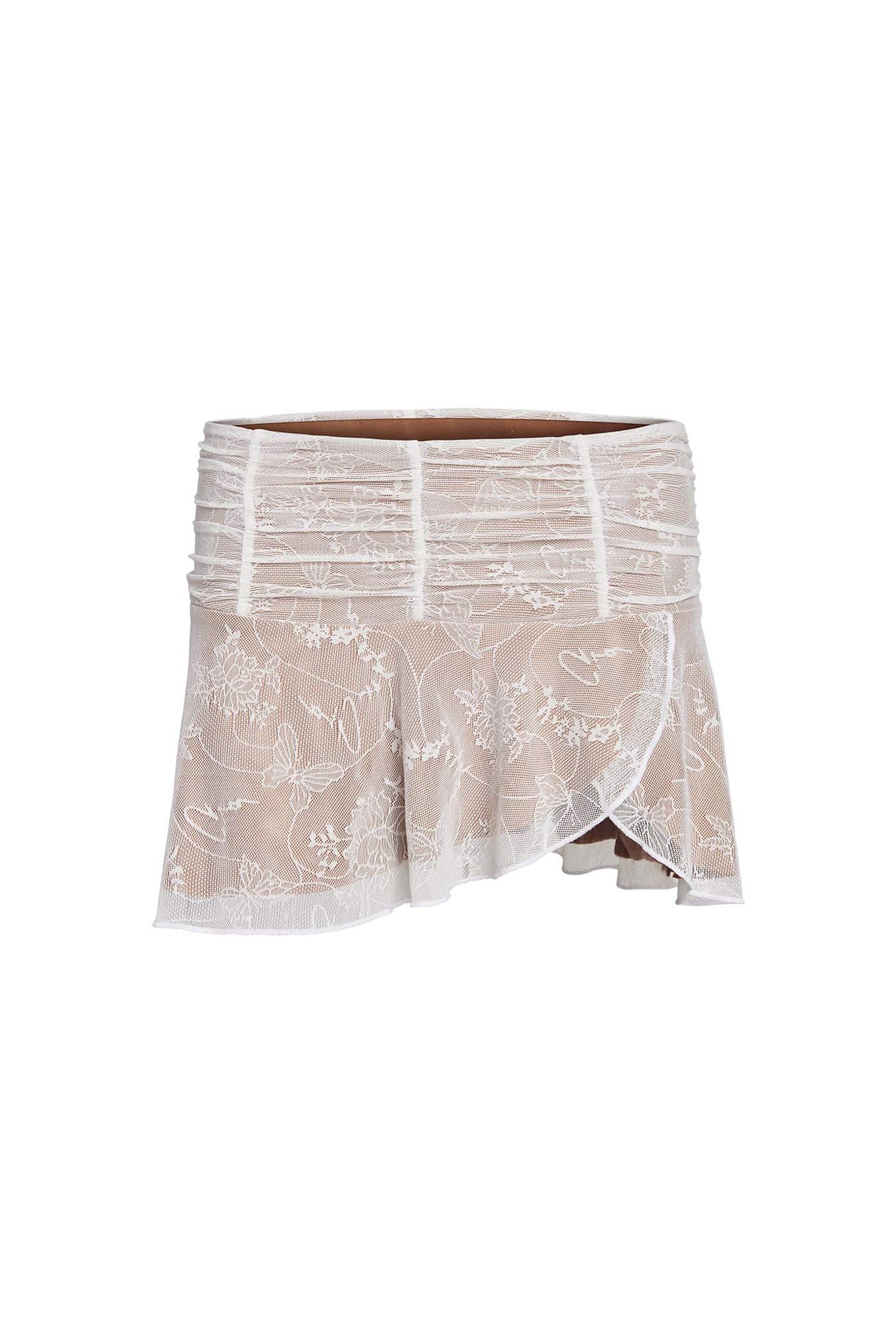 The I.AM.GIA Yvette Skirt in white, featuring beautiful butterfly lace detailing, is a beige mini skirt with an asymmetrical hem. It boasts intricate white floral lace embroidery and a gathered, ruched waistband for added texture and style.