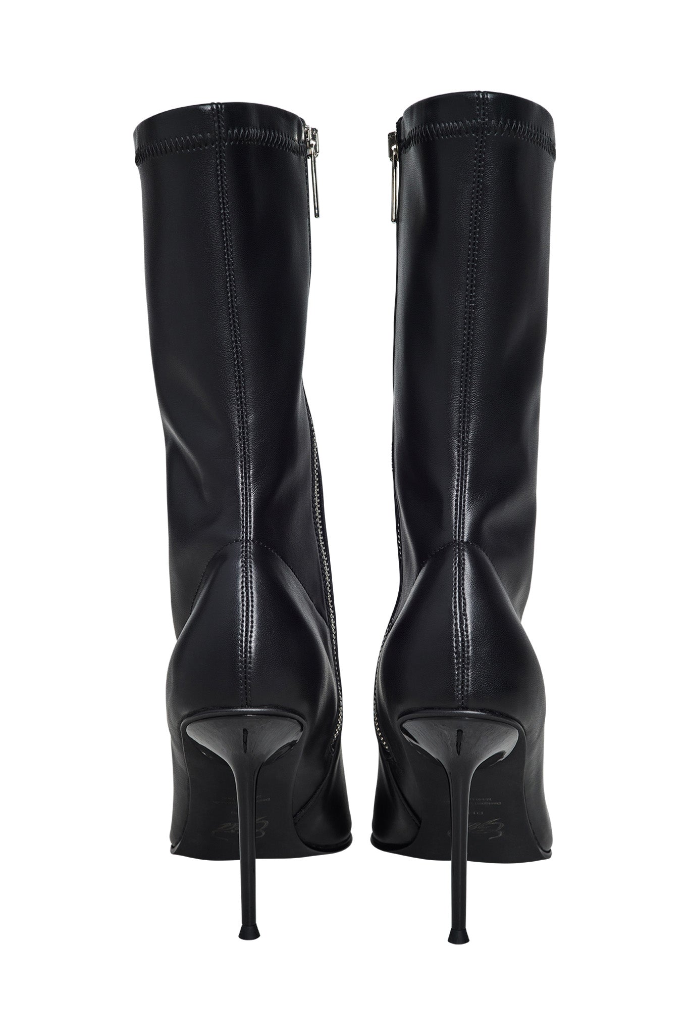 The YANA BOOT - BLACK by I.AM.GIA are high-heeled stiletto boots featuring pointed toes and side zippers. The back view highlights their sleek design and smooth leather material.