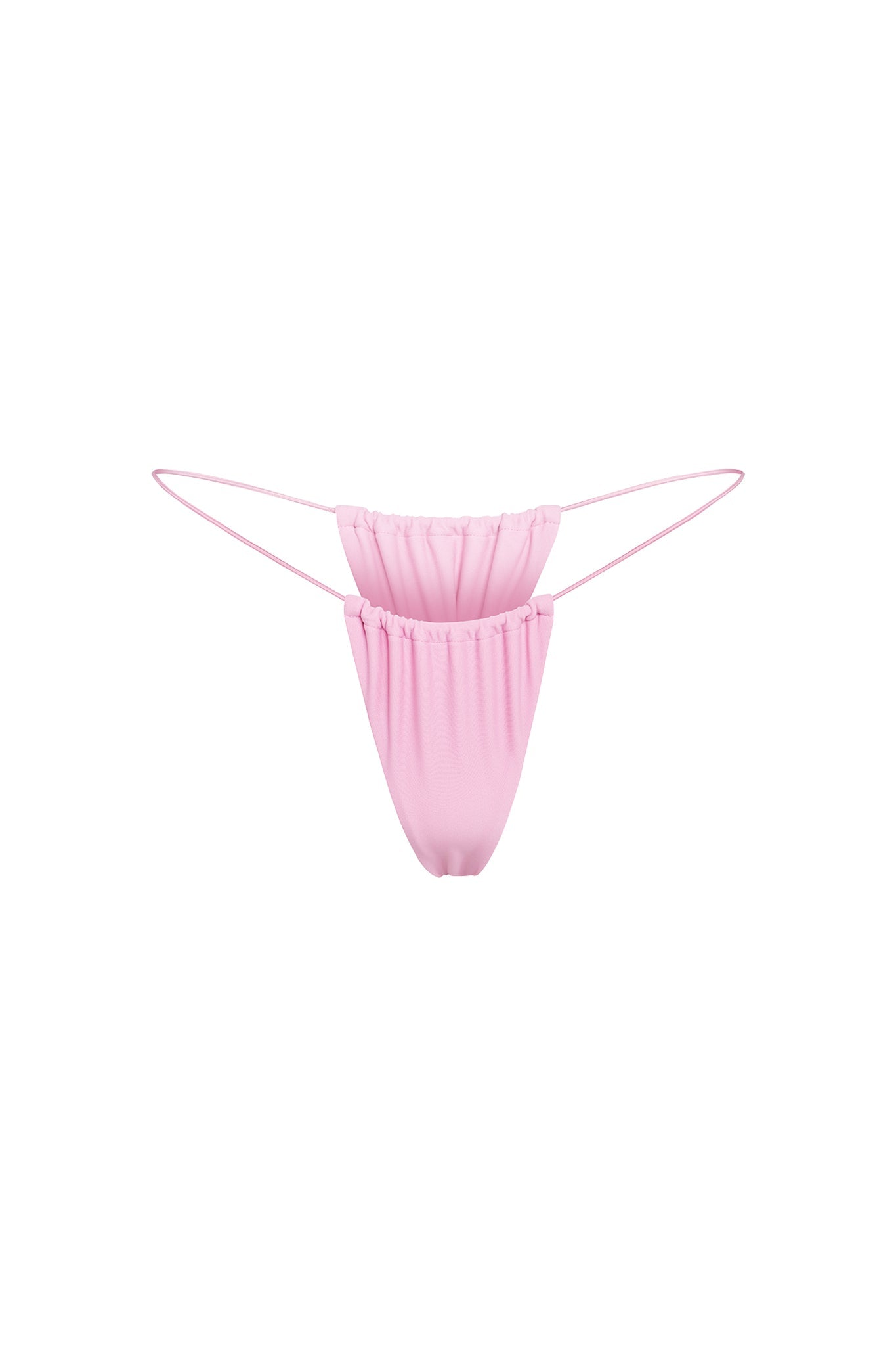 The BAMBI BIKINI BOTTOM - PINK : BUBBLEGUM by I.AM.GIA is a minimalistic, light pink bikini bottom that features a scrunchie-style design at the front and thin side straps. Made from a soft and stretchy fabric, it offers a gathered texture with minimal coverage, suggesting it's designed for a revealing fit.